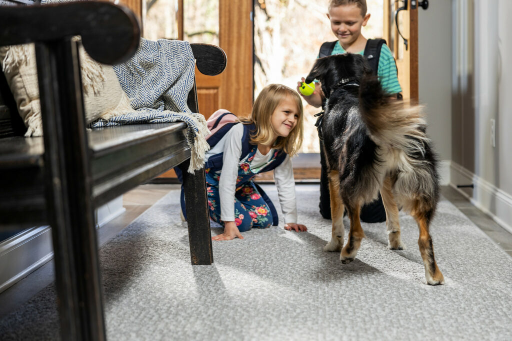 Kids plying with dog on carpet flooring | Jack's Carpet & Tile
